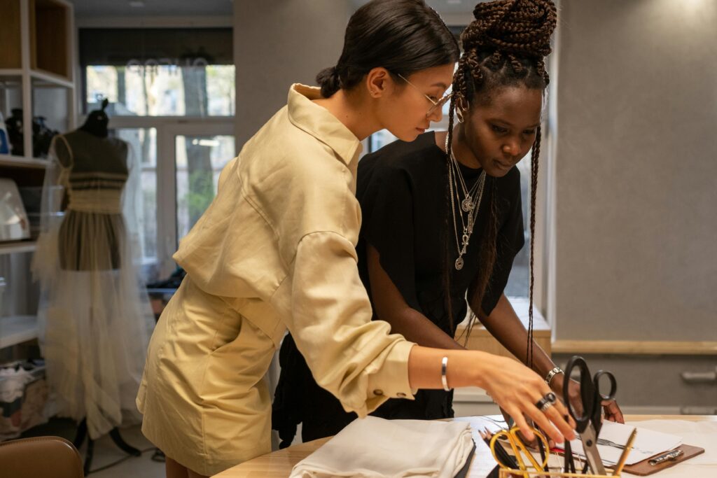 pexels-photo-9850415-9850415 Two female fashion designers working together in an atelier environment, discussing and creating designs.